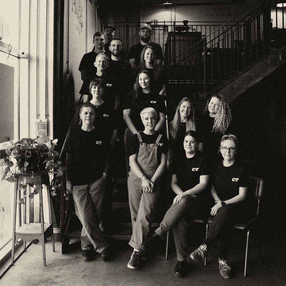 The Coaltown team gathered on a staircase in the roastery