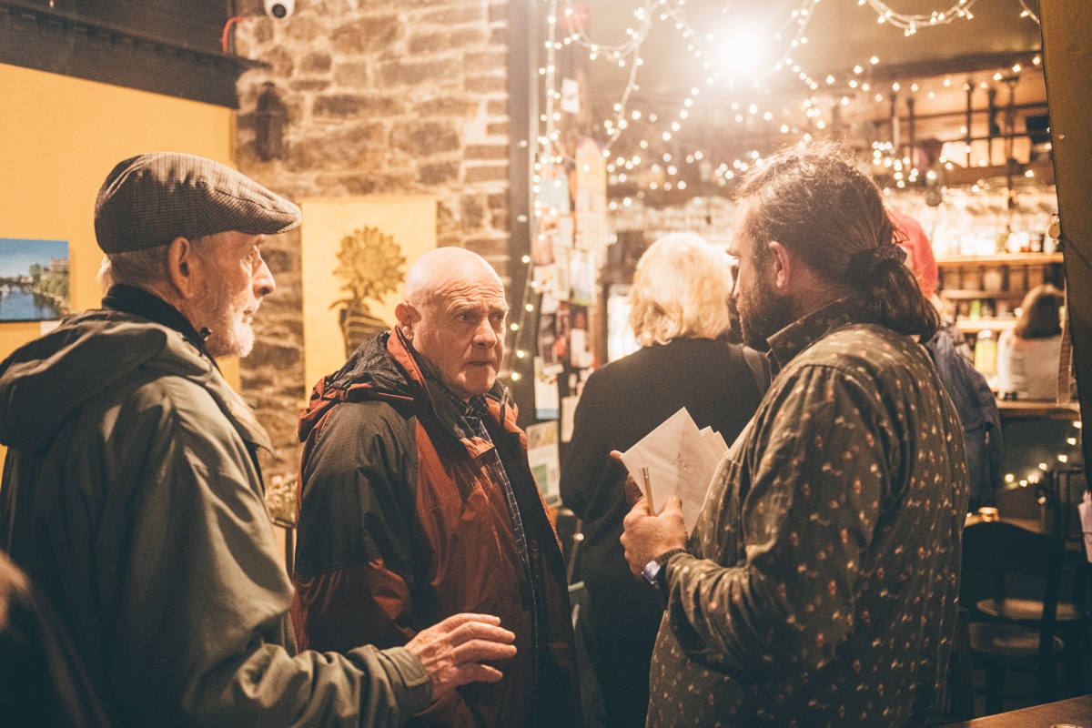 People talking at the bar at The Warren, fairy lights overhead