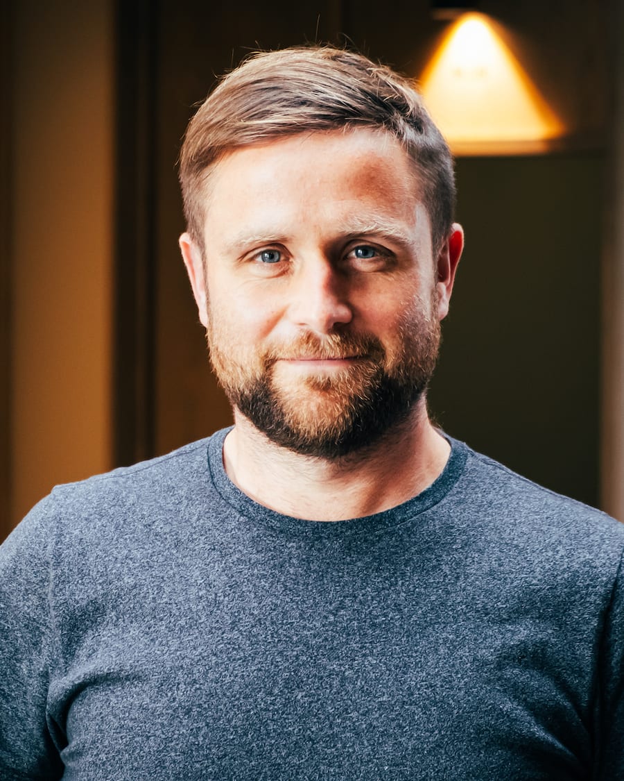 Berian, indoors, in a grey t-shirt