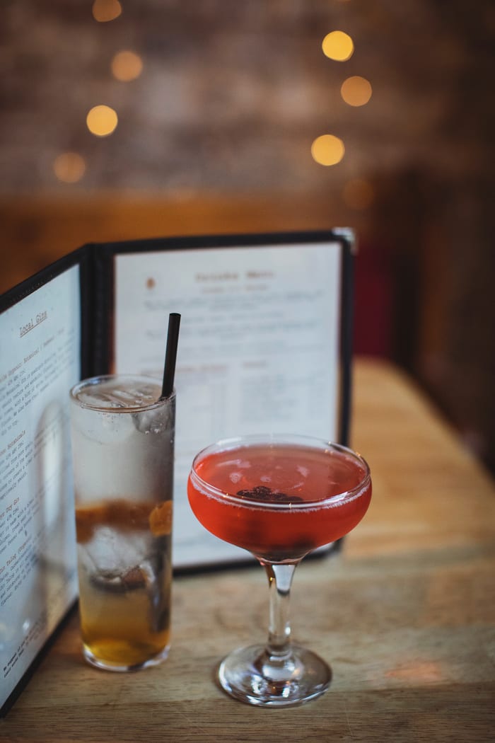Cocktails, with the drinks menu behind