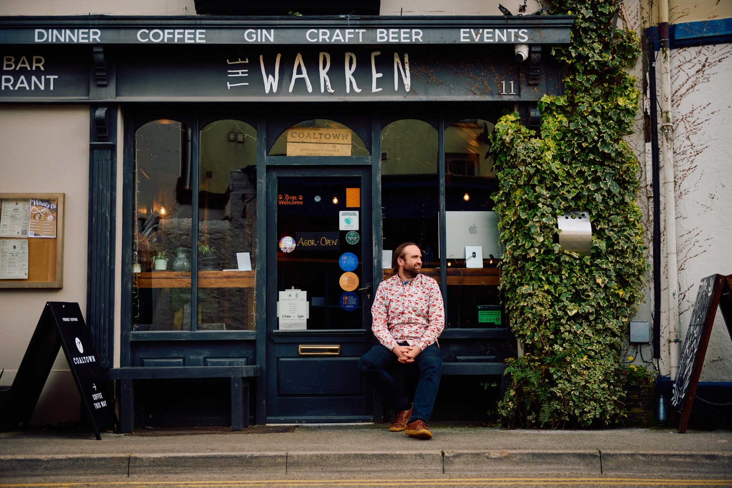Deri Reed sitting on the step outside The Warren, 11 Mansel Street