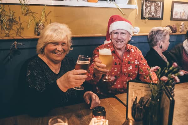 Two people toasting at the bar