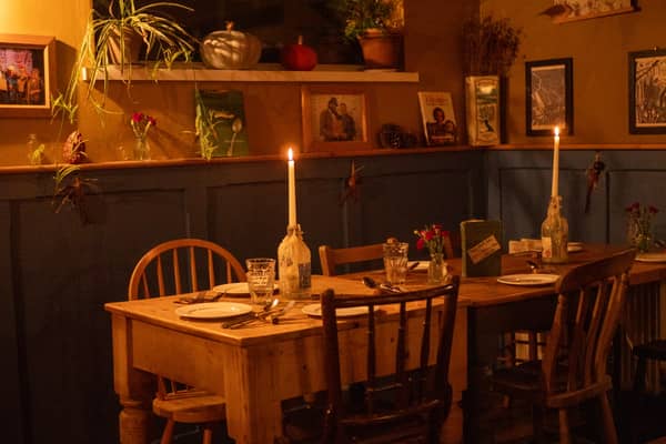 A table laid by candlelight in the front room